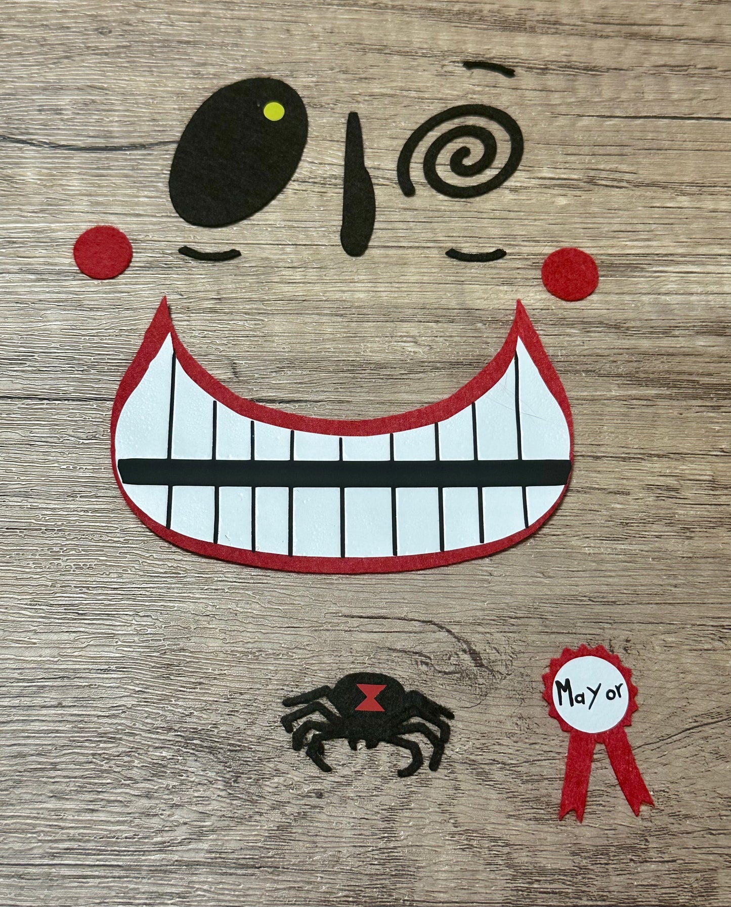 Character felt face appliqué with heat-activated backing