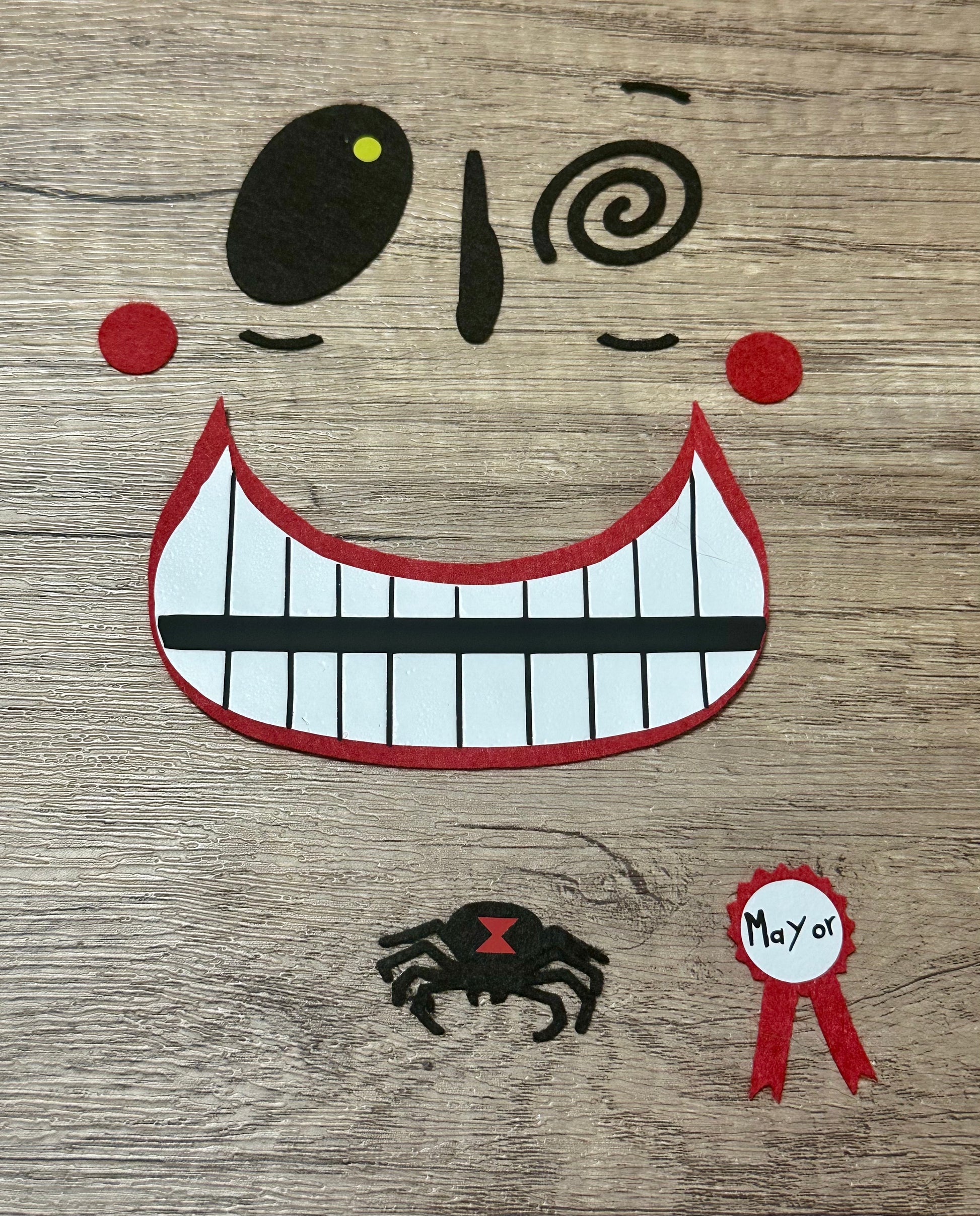 Character felt face appliqué with heat-activated backing
