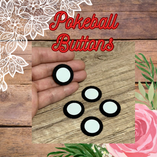 A set of white felt Pokeball buttons displayed on a wooden surface with a hand holding one button and a background decorated with a floral design and a wooden texture.