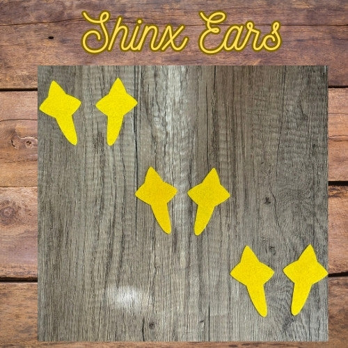 Yellow star-shaped objects on a wooden background with 'Shinx Ears' text.