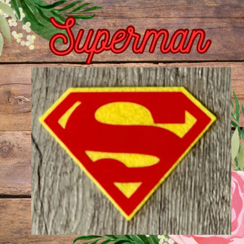 Superman logo on a wooden background with 'Superman' text above